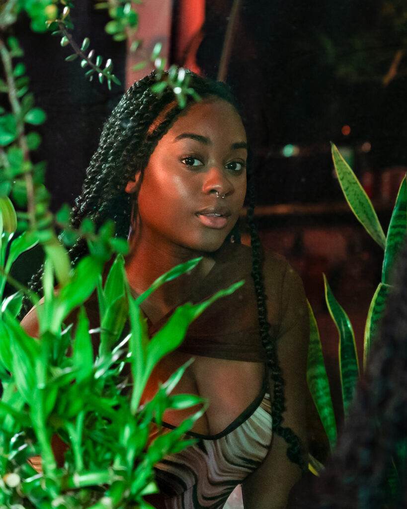 Portrait of woman in mirror, with plants