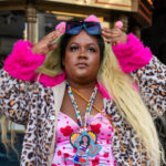 Woman in leopard and pink posing for portrait