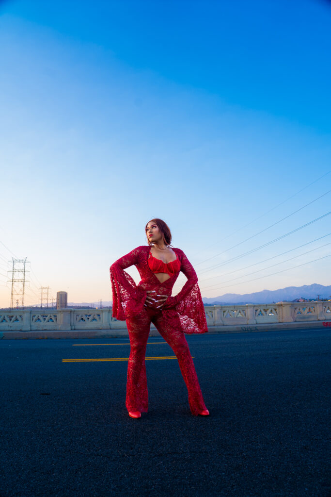 Woman in red outfit posing for photo in the street