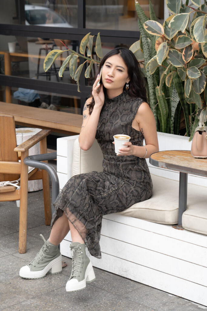 Lifestyle portrait of woman getting coffee on cell phone