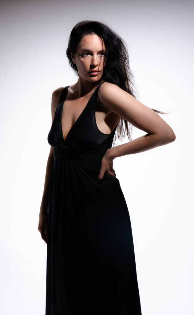Woman in black dress posing dramatically