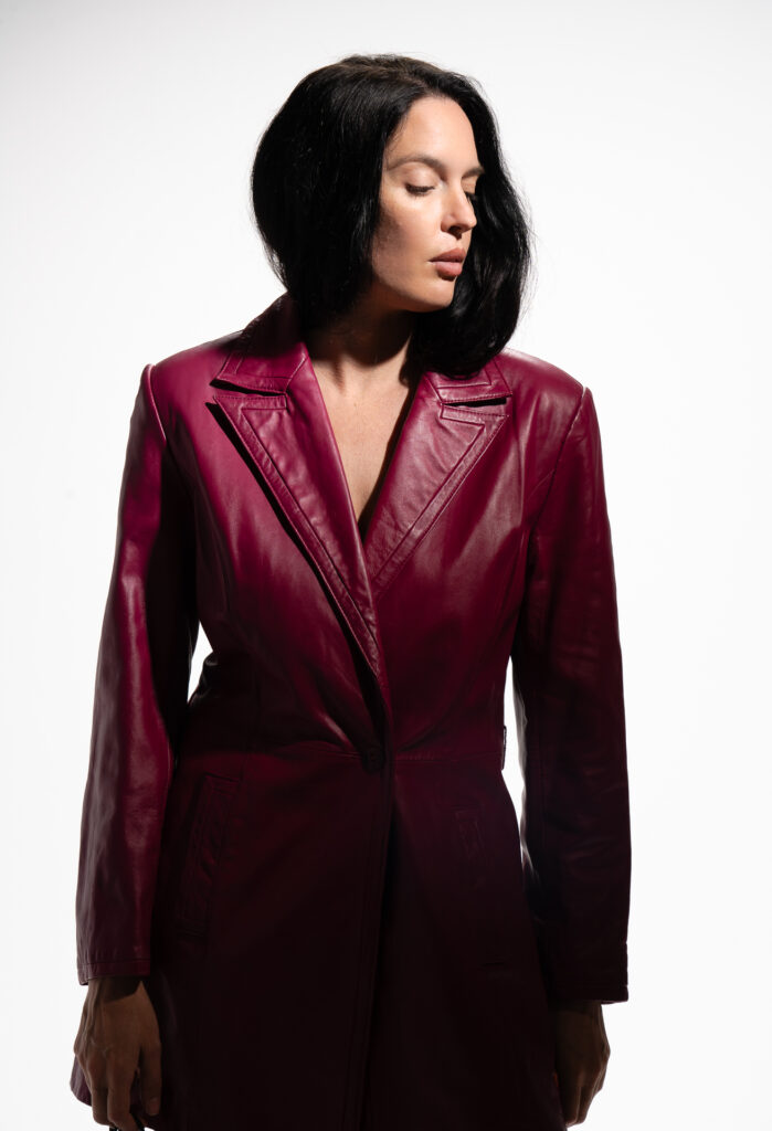 woman in maroon leather jacket