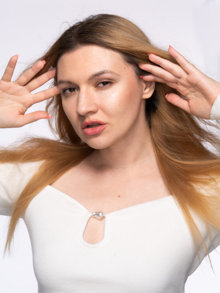 Model posing with hair blowing back from face